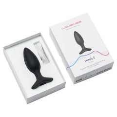 Hush 2 black silicone plug shown inside open white box beside retail packaging, size S