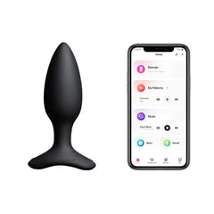 Hush 2 butt plug beside smartphone displaying Lovense app with pattern and music controls