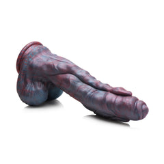 Hydra dildo laying on its side showing curved shaft and sculpted base detail
