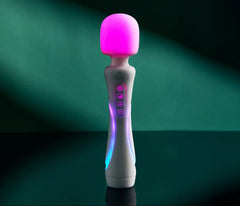 Illumination wand vibrator glowing pink with multicolour body LEDs on teal background