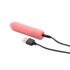 ILY The Bullet coral vibrator connected to USB magnetic charging cable showing charging port