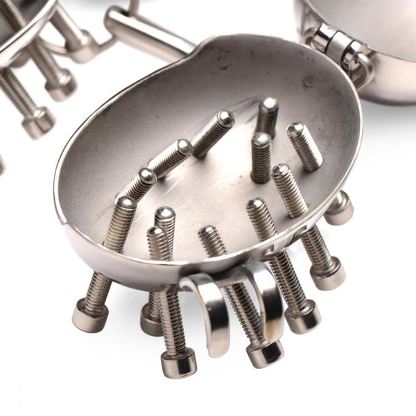 Close-up interior of one egg shell showing adjustable threaded spike bolts in brushed steel finish