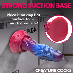 Intruder alien dildo mounted on flat surface demonstrating strong pink suction cup base