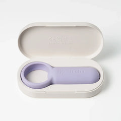 Iroha paiRING nestled in its oval wireless charging case, lid open