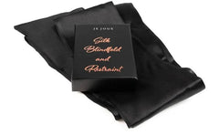 Je Joue black satin silk blindfold and restraint set laid flat beside branded packaging