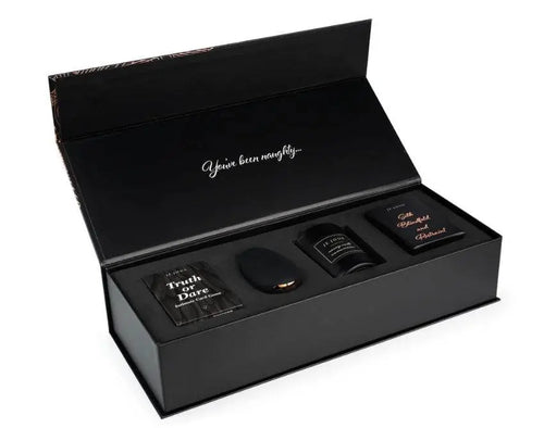 Je Joue Naughty Gift Set open box showing vibrator, candle, cards, and silk accessories