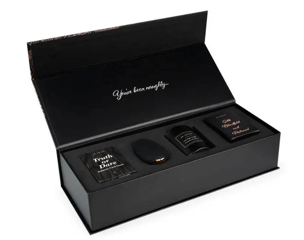 Je Joue Naughty Gift Set open box showing vibrator, candle, cards, and silk accessories