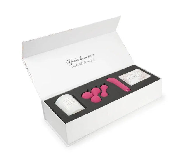 Je Joue Naughty and Nice Gift Set open box showing pink vibrator, kegel balls, candle, and cards