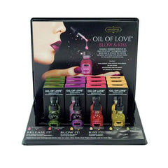 Kama Sutra Oil of Love retail display with twelve warming body oil bottles in assorted flavors