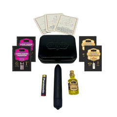 Kama Sutra Weekender Kit contents laid flat: black bullet vibrator, massage oil, lubricant sachets, position cards, battery