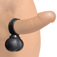 Large black silicone vibrating ball ring shown fitted on a realistic model for scale reference