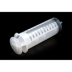 Large enema syringe angled view on dark background highlighting plunger grip and barrel