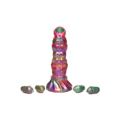 Larva Ovipositor Dildo standing upright with four silicone eggs arranged at its base