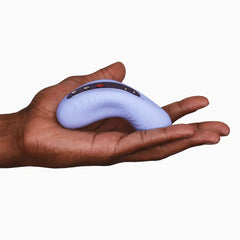 Laya III massager resting in an open palm showing its compact hand-friendly size in soft lavender silicone