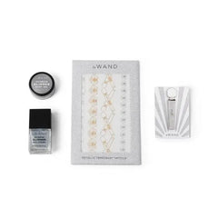 Le Wand All That Glimmers set accessories: glimmer nail polish, body gel, and temporary tattoos