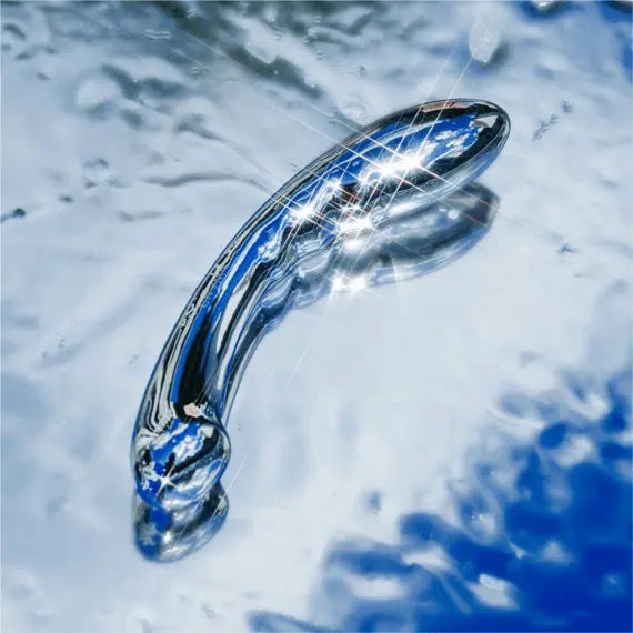 Le Wand Arch polished stainless steel dildo submerged in water showing waterproof design