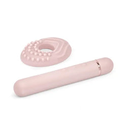 Le Wand Baton slim vibrator beside its removable silicone textured ring accessory