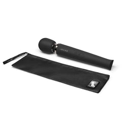 Le Wand black wand massager beside its included black satin storage pouch
