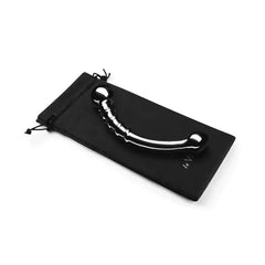 Le Wand Bow curved steel dildo resting on black drawstring storage pouch included with purchase