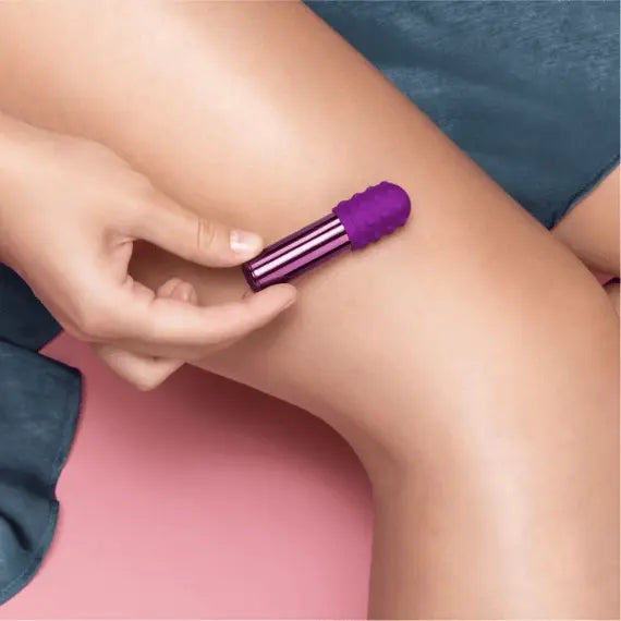 Le Wand Bullet vibrator being applied to the back of a knee for external massage use