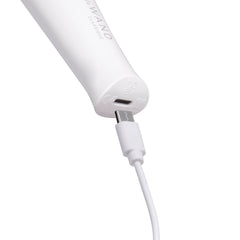Close-up of Le Wand Classique Mini USB-C charging port at base of white handle with cable inserted