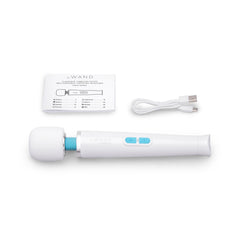 Le Wand Classique Petite laid flat with USB-C charging cable and multilingual instruction booklet