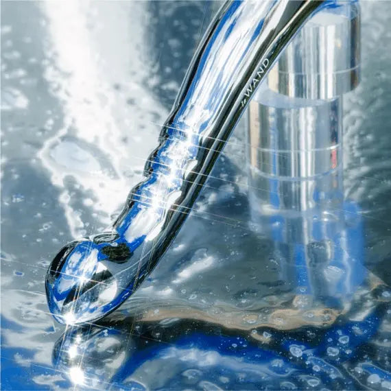 Le Wand Contour stainless steel wand being rinsed under running water, waterproof