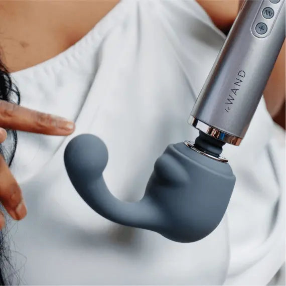 Le Wand Curve attachment connected to wand handle, held near body in lifestyle context
