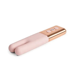 Le Wand Deux mini vibe lying flat, showing split silicone tip and rose gold metallic handle detail