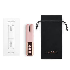 Le Wand Deux vibrator displayed beside its quick-start guide and black satin drawstring storage pouch