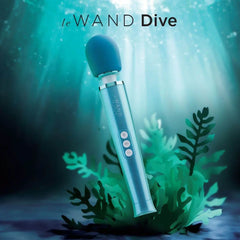 Le Wand Dive vibrating wand massager in teal, shown against an underwater seascape backdrop