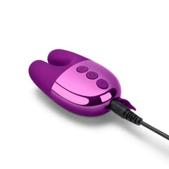 Le Wand Double Vibe connected to charging cable via magnetic port at base of metallic body
