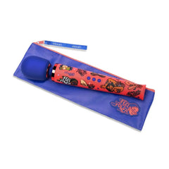 Le Wand Feel My Power wand vibrator resting on blue branded storage pouch with wrist strap
