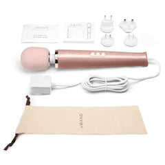 Le Wand full unboxing flat lay with massager, cord, adapters, storage pouch, and user guide