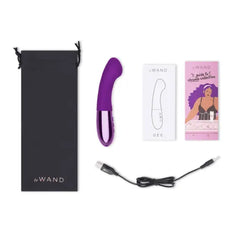 Le Wand Gee unboxed contents: vibrator, USB cable, storage bag, and instruction guides