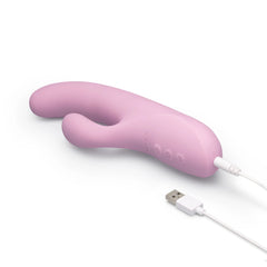 Le Wand Hither lying flat with white USB charging cable attached, showing rechargeable functionality