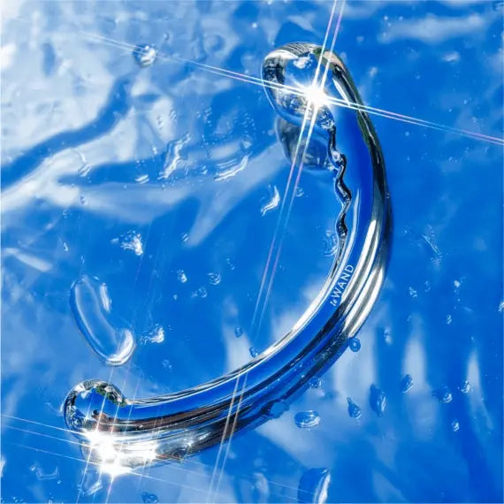 Le Wand Hoop polished stainless steel wand submerged in water, showing waterproof design