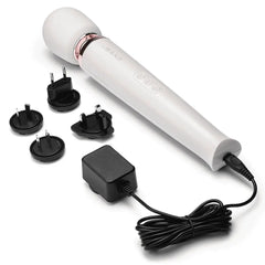 Le Wand massager with AC charger and four international plug adapters on white background