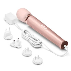 Le Wand massager displayed with four international plug adapters for global travel compatibility