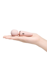Le Wand Mini Microwand resting in open palm demonstrating its compact pocket-friendly size