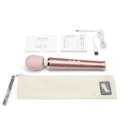 Le Wand Petite complete kit with pouch, USB cable, and guide booklets laid flat