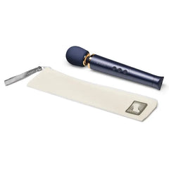 Le Wand Petite massager beside its cream zip travel pouch with silver branded zipper pull