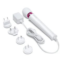 Le Wand Petite massager displayed with four international plug adapters for global travel use