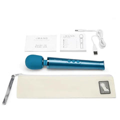 Le Wand Petite Massager displayed with storage pouch, USB cable, and two instruction booklets