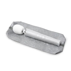Le Wand Petite wand massager resting on included silver glitter storage pouch
