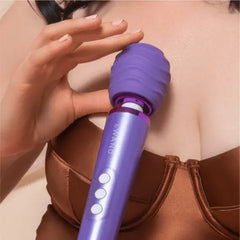 Close-up of Le Wand Petite massager with ribbed silicone cover held near the chest and shoulder