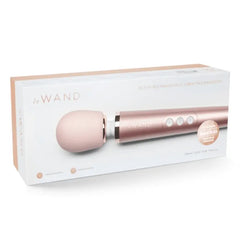 Le Wand Petite Massager in rose gold shown inside its retail gift box packaging
