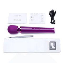 Le Wand Petite massager with storage pouch, USB charging cable, and guide booklets laid flat