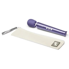 Le Wand Petite Massager in violet beside included cream zippered storage pouch