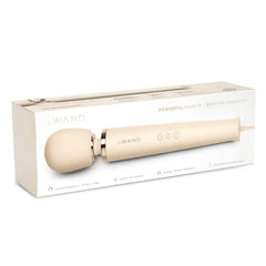 Le Wand Plug-In Vibrating Massager cream displayed beside its minimal white retail box